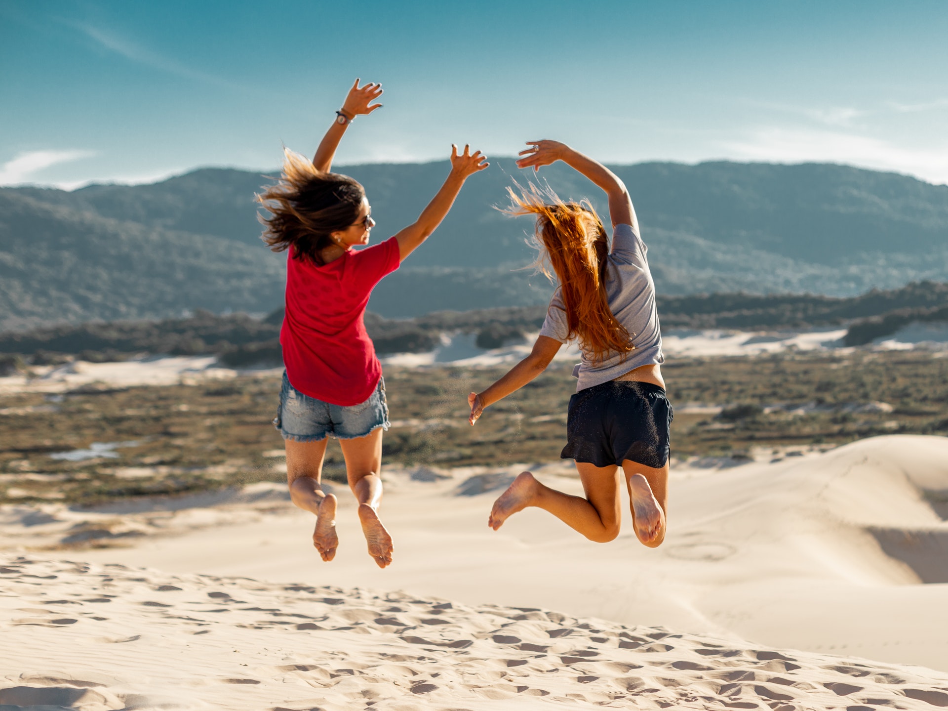 jump-shot-photography-of-two-women-2597365